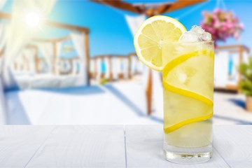 Lemonade with fresh lemon on  background