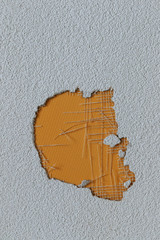 hole in the plaster wall covered by yellow surface