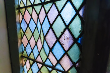 Damaged and buckled stain glass windows requiring repair.