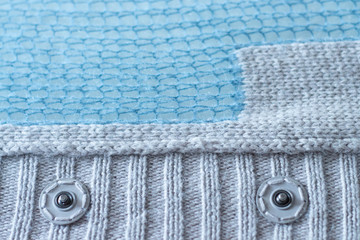 Wool sweater, blue and beige background, blurred texture