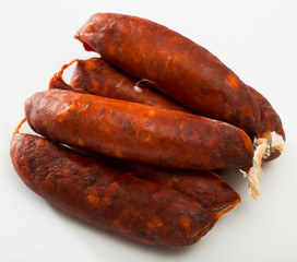 Sausages chorizo on white surface