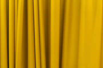 Fabric yellow curtains. Abstract background, curtain, drapes gold fabric. Crumpled cloth, folds of...