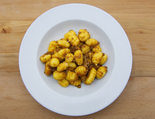 Homemade potato gnocchi with bolognese sauce (ragu) on a white plate 