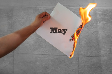 May word text on fire with burning paper