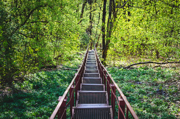 Obraz premium Iron stairs for tourists going down. The road to the spring