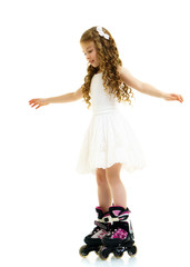 Little girl on roller skates.