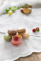 Macarons on white background and rustic wooden table