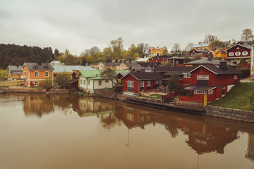 Porvoo, Finland - may 2019: cobbled streets of medieval village. river and it's scenic row of old rust-red warehouses