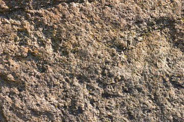 Background of granite. Texture of granite stone. Pattern of roughened surface. Texture of brown stone
