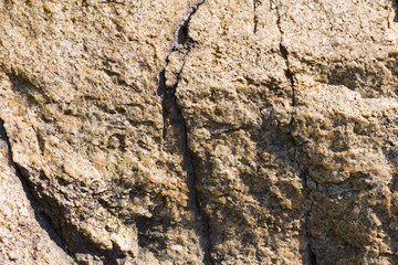 Background of granite. Texture of granite stone. Pattern of roughened surface. Texture of brown stone