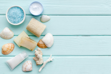 spa organic cosmetics, cream, lotion, salt, soap with Dead Sea minerals on mint green background flat lay space for text