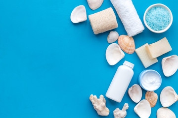 organic cosmetic set with Dead Sea salt, cream and lotion on blue background top view mock up