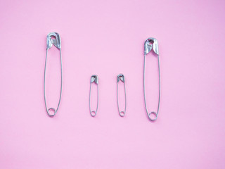 Several safety pins representing an unconventional family of gay, lesbian or transgender