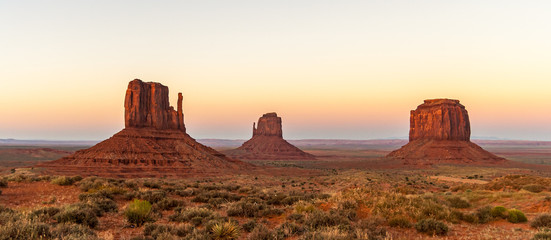 Fototapeta na wymiar Famous Mitten Buttes or mesas, landmark of the Monument Valley Navajo Tribal Park. Beautiful natural scenery at dusk. Arizona, USA.