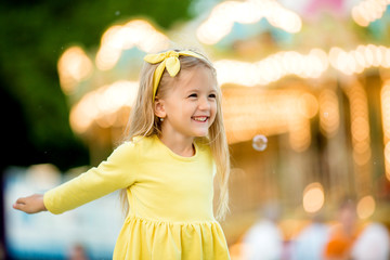 Portrait of baby girl smiling in amusement Park, Happy healthy baby child having fun outdoors on...