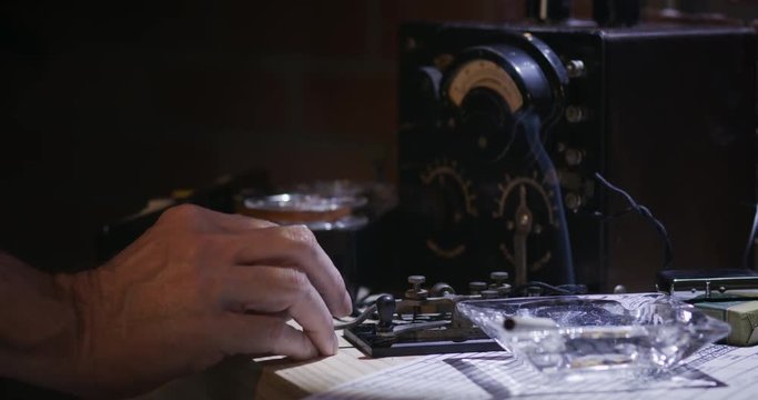 A cold war era spy radio transmitting with a tape recorder on in the background.