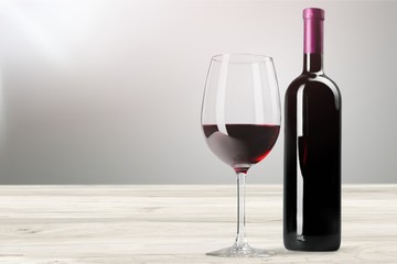 Red wine glass on wooden desk at
