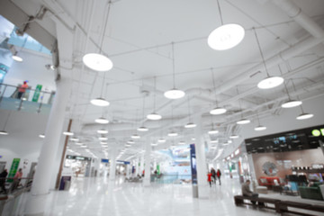 Shopping center led lighting. Ceiling lights in the mall. Retail concept. Customers and shoppers in...