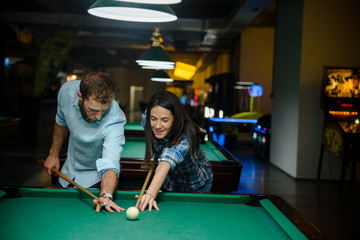 Fototapeta premium Happy couple playing snooker together