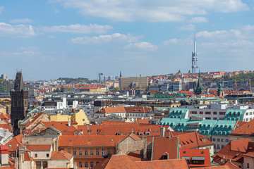 Fototapeta premium Aerial panoramic top view above old town and city skyline with famous attraction; The Powder and Henry's Tower and Television Tower against blue sky on sunny day in summer in Prague, Czech Republic.