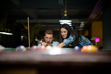 Happy couple playing snooker together