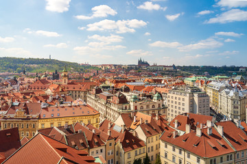Fototapeta na wymiar Outdoor sunny panoramic aerial scenery of rooftop in old town, city skyline, Charles Bridge tower and background range of mountain with Prague Castle and St. Vitus Cathedral in Prague, Czech Republic.