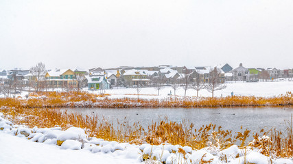 Clear Panorama Panorama of a lake in Daybreak Utah with wooden decks and snowy shore in winter