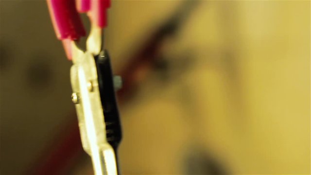 Man Lubricating A Pickup Tool or Grabber Stick using a Spray Can. Close Up.  