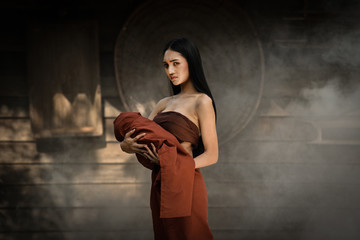 Woman Ghost drama and carrying her baby ghost standing on old thai house