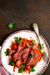 Vegetable salad with roast beef. Top view with copy space.