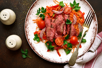 Vegetable salad with roast beef. Top view with copy space.