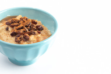 Cinnamon Raisin Oatmeal in a Blue Bowl on a White Background