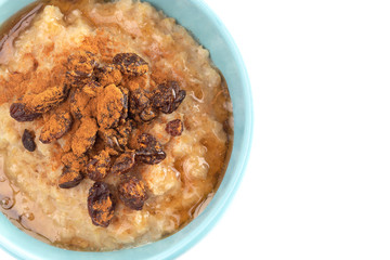 Cinnamon Raisin Oatmeal in a Blue Bowl on a White Background