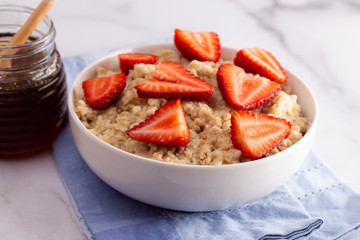 Oatmeal with Strawberries on a White Marble Table