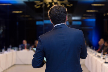Young businessman at business conference room with public giving presentations. Audience at the conference hall. Entrepreneurship club.