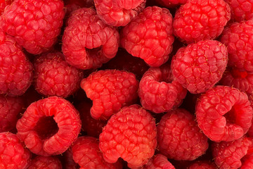 Top view on a stack of fresh raspberries as abstract background. Copy space for your text.