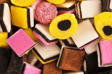 Top view on a stack of licorice candies as abstract background. Macro details.