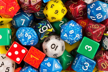 Top view on a stack of role playing game dice as abstract background. Macro details.