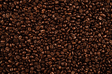 Top view on background texture of coffee beans. Copy space for your text.