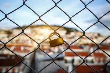 lock on the lattice. The roofs of the old city on a blurred background.