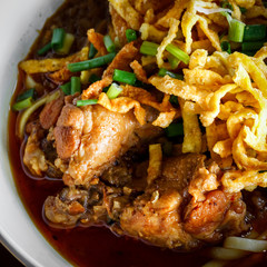 close up Northern Thai Noodle in Chicken coconut milk Curry soup ( Khoa Soi Kai)