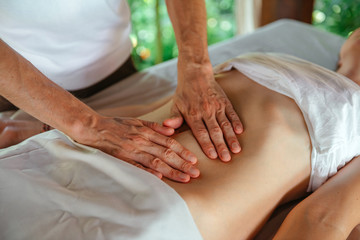 Fototapeta na wymiar Massage the abdomen. Master's hands.