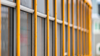 Panorama Exterior view of a yellow school bus with a close up on the glass windows