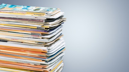 Pile of newspapers on white background