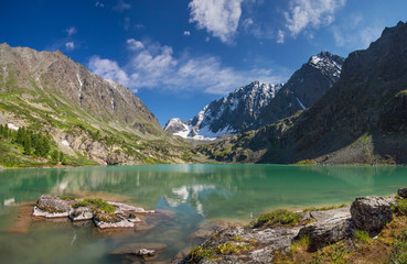Fototapeta na wymiar A picturesque lake in the mountains of Altai, travels in Russia. Summer vacation in the mountains.