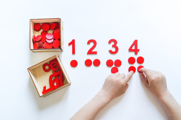 Montessori material. Children's hands. The study of mathematics