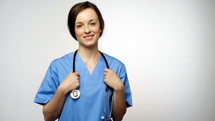Portrait of Smiling doctor or nurse with a stethoscope at hospital. Concept: profession, medicine, medical education.