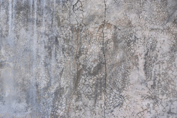 Grunge grey concrete wall with crack and stains in industrial building. Cement texture for design and background.
