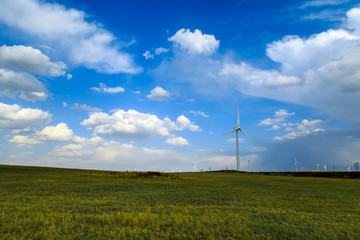 Fototapeta na wymiar A windmill that generates electricity on the prairie