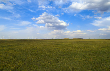 A windmill that generates electricity on the prairie